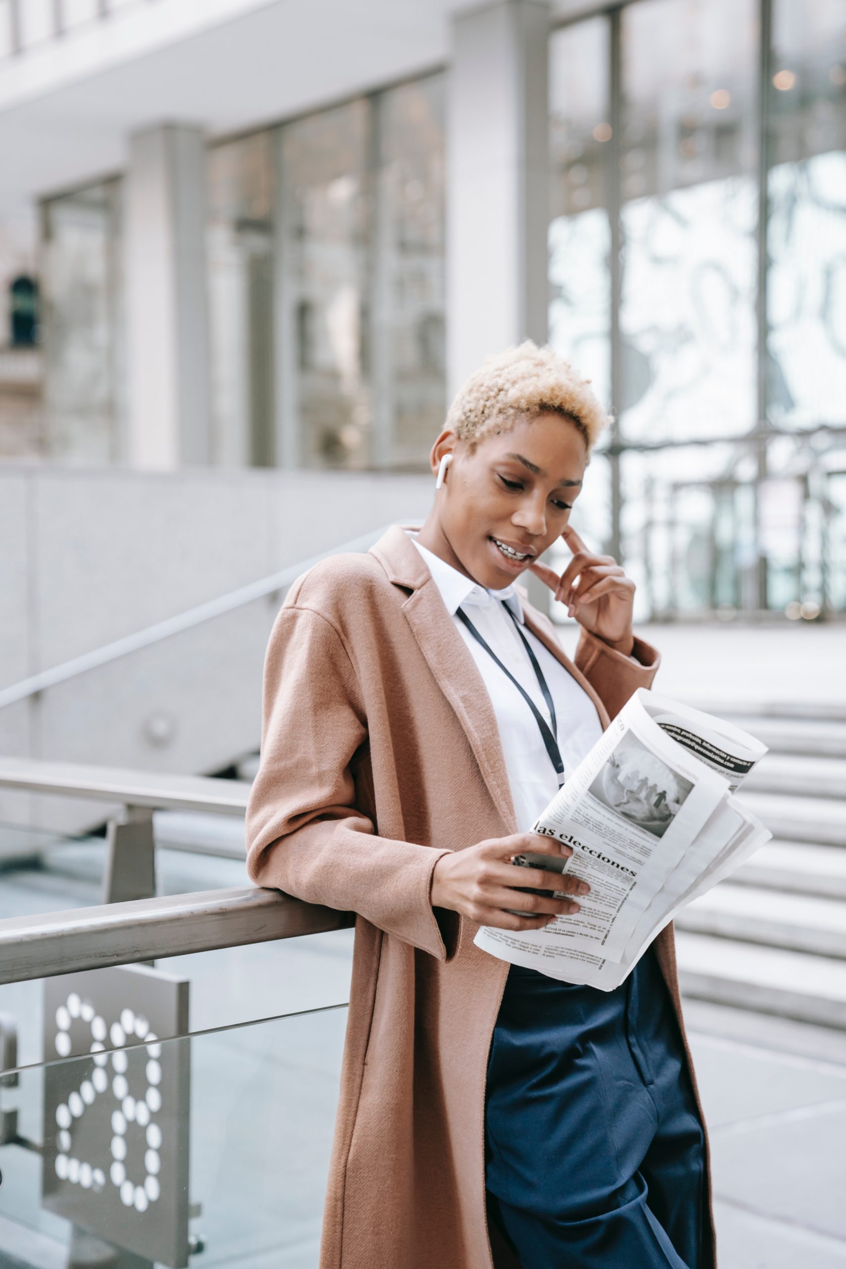 Black woman outside reading a newspaper