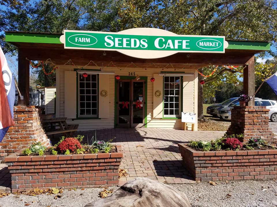 a small cabin with a sign that says Seeds Cafe